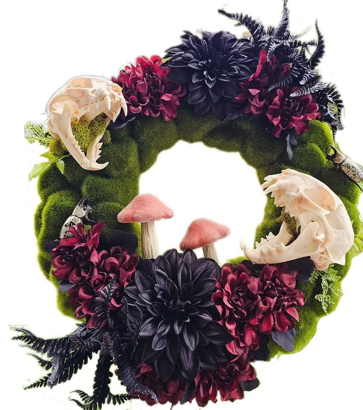 Gothic botanical wreath with moss, dark flowers, mushrooms, insects, and small skulls.